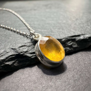 Pendant with natural yellow sapphire made of silver on a chain