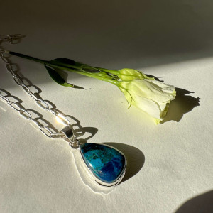 The Chrysocolla pendant is natural in silver