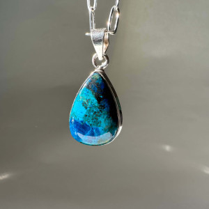 The Chrysocolla pendant is natural in silver