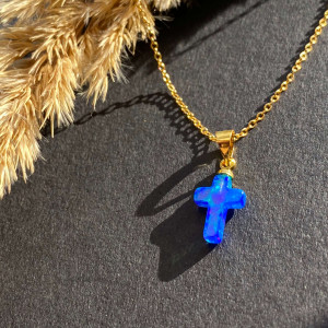 Pendant with a cross from Opal on a silver chain in gilding